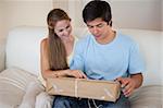 Couple looking at a package in their living room