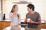 Couple having a cup of tea in their kitchen