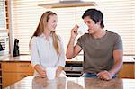 Smiling couple having a cup of coffee in their kitchen