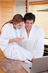 Portrait of a couple having breakfast during a video conference in their kitchen