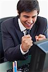 Portrait of a cheerful businessman working with a computer in his office