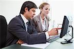 Good looking business people working with a computer in an office