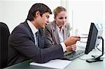 Focused business team working with a computer in an office