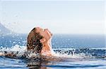 Gorgeous woman raising her head out of the water in a swimming pool