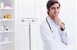 Young doctor standing in his examination room