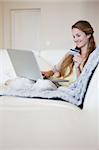 Young woman on the sofa doing online shopping