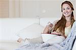 Young woman with a bowl of popcorn watching a movie