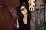 Pretty fairy with loupe glasses in rustic location