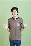 Hispanic teen with open hands over green background