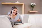 Young woman shopping online on her sofa