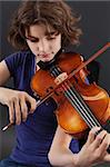 Photo of a young girl playing the violin.