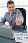 Thumb up given by sitting businessman