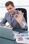 Businessman sitting at his desk giving his approval