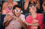 Happy Caucasian couple with 3D glasses in theater