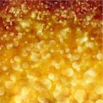Festive gold Christmas abstract background with bokeh lights and stars.