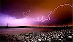 LIghtning Strikes over rocks and water