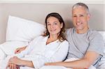 Couple lying on a bed in the morning