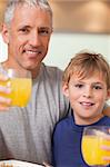Close up of a boy and his father having breakfast in a kitchen