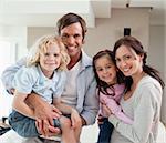 Charming family posing together in a living room