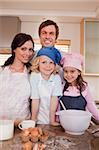Portrait of a family baking together in a kitchen