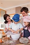 Portrait of a family baking in a kitchen