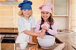 Siblings baking together in a kitchen