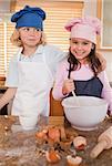 Portrait of siblings baking together in a kitchen