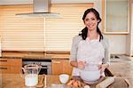 Smiling woman baking in her kitchen