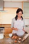 Portrait of a smiling woman baking in a kitchen
