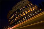 photo of the roman colosseum taken by night with dark blue sky