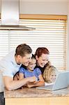 Family exploring the internet in the kitchen together