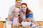 Family together with baking ingredients in the kitchen