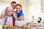 Cheerful happy family preparing dough