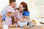 Happy young family enjoys baking together