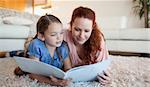 Mother and daughter looking at a magazine together