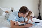 Father doing reading exercises together with his son