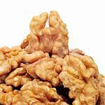 a pile of shelled walnuts on a white background