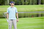 A young man with a golf club on the field