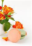 traditional french macarons with roses on the background