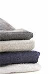 A pile of warm knitted gray sweaters