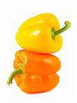 Stack of yellow and orange peppers isolated on white background