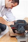 Home improvement - cutting the laminate flooring planks, focus on hand