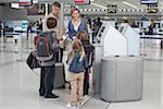 Family Checking In at Airport