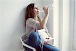 Pregnant woman drinking water from bottle