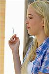 Young woman smoking cigarette