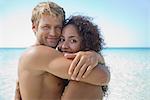 Couple embracing at the beach, portrait