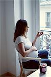 Pregnant woman eating toast with jam