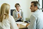 Businesswoman talking with clients in office