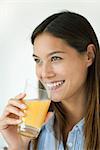 Young woman drinking orange juice