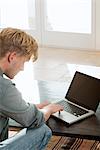 Man using laptop computer at home